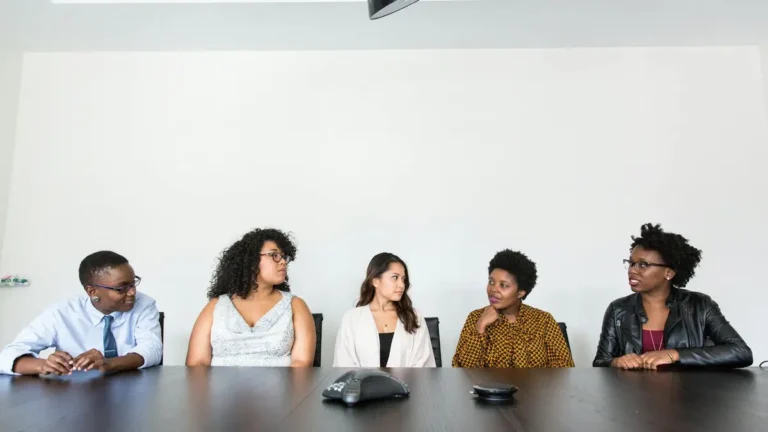 A diverse group of professionals having a meeting in a modern office setting. Teamwork and collabora